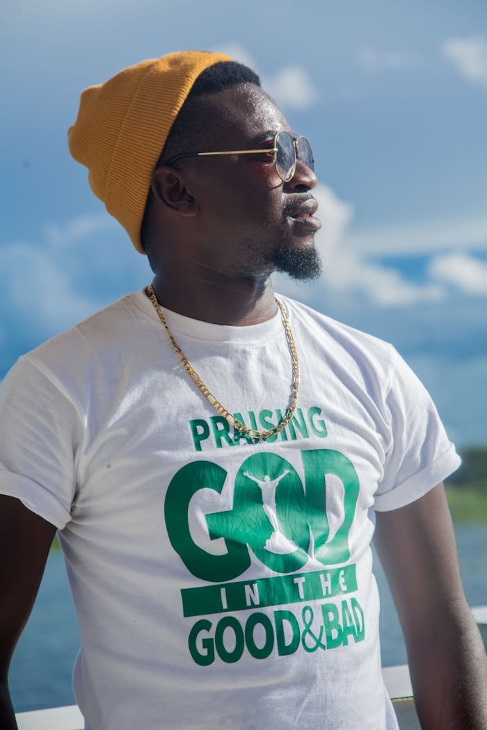 Stylish man with sunglasses and beanie looking away outdoors in Zambia.